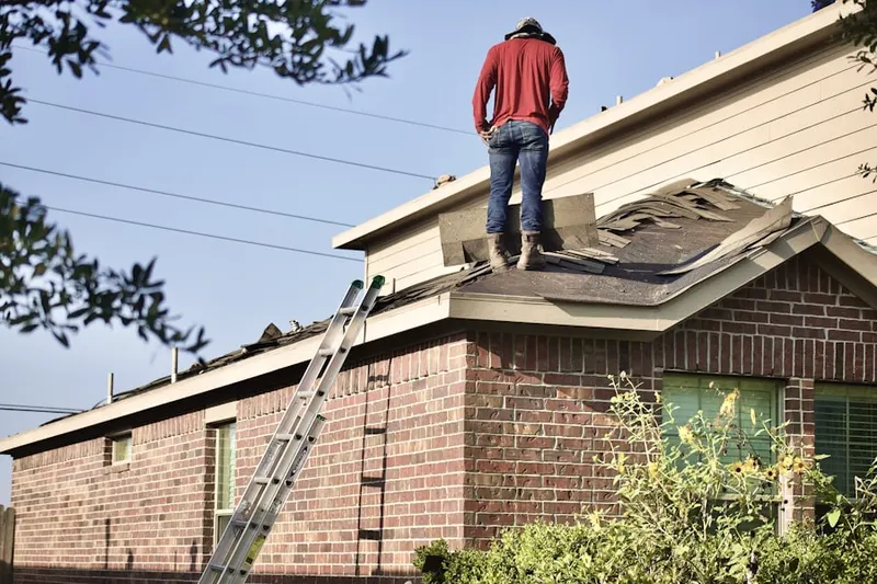 Professional roofer working on a residential roof in El Paso